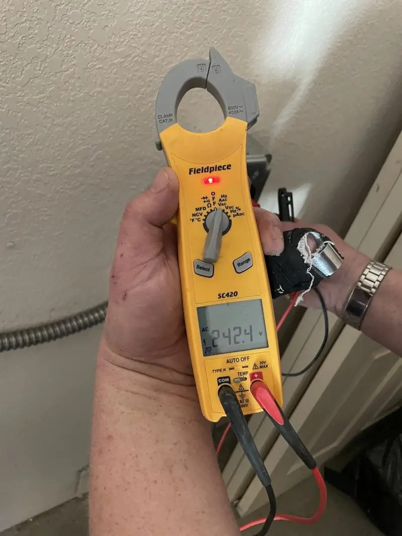Voltage testing with clamp meter during Ceiling Fan Installation in Box Elder